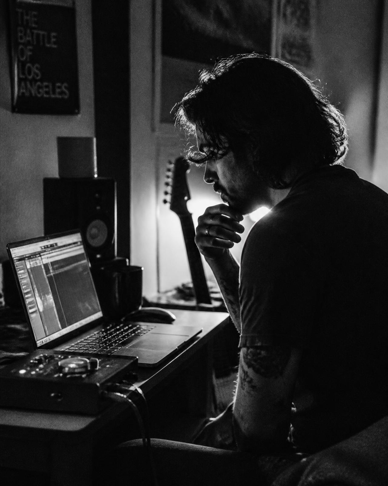 Independent musician working on a release in a home studio